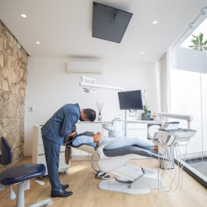 Dentist performing dental treatment on his patient in the chair